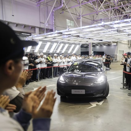 A Tesla Model 3 vehicle set to be delivered to a company employee moves off an assembly line during a ceremony at the company's Gigafactory in Shanghai. Photo: Bloomberg