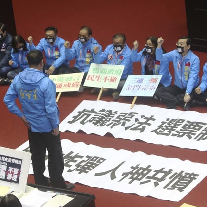Opposition Kuomintang lawmakers protest against the bill in the legislative chamber in Taipei on Tuesday. Photo: AP