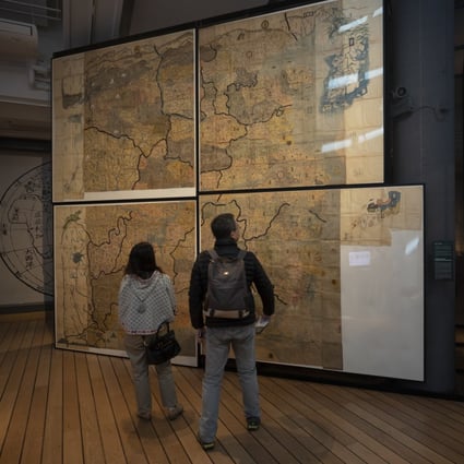 People looking at the Huang-Ming Yitong Da Tu (Unified Atlas of the August Ming) at the Hong Kong Maritime Museum, part of an exhibition called “The World on Paper: From Square to Sphericity”. Photo: Antony Dickson