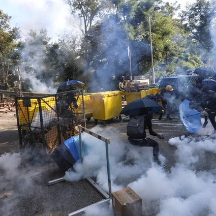 Riot police fire tear gas to disperse anti-government protesters from the road in front of Chinese University in Sha Tin on November 11. Photo: Felix Wong