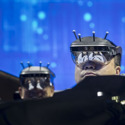 Visitors wearing virtual reality (VR) headsets try a driving system at a Nissan Motors booth during the CES Asia Show in Shanghai, China, on Tuesday, June 11, 2019. Photo: Bloomberg