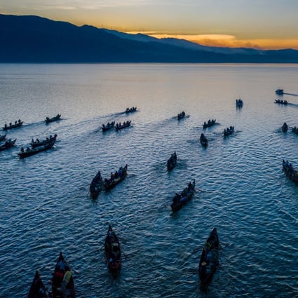 Fishing boats sailing on Xingyun lake in Yunnan province. Photo: Xinhua