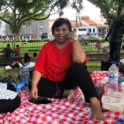 Indonesian domestic workers Sofia Marsudin, 49, and Sadiam Sadin, 47, enjoy a Sunday picnic. For many foreign workers in Singapore, it is difficult to find a safe and comfortable space to spend their day off. Photo: Kok Xinghui