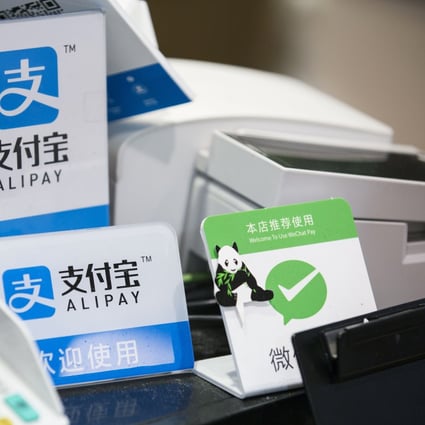 Signs for Ant Financial Services Group's Alipay, center top and center bottom, and Tencent's WeChat Pay, right at a store in Tokyo, Japan. File photo: Bloomberg
