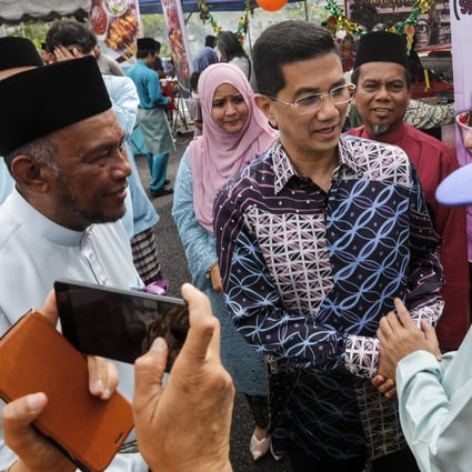 Malaysian Economic Affairs Minister Azmin Ali (C). Photo: EPA-EFE