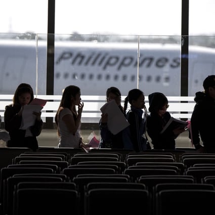 Filipino workers arrive at Manila International Airport after a flight from Kuwait. Photo: AFP