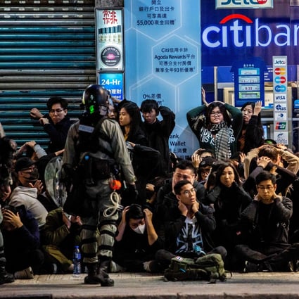 Police detain a group of people after a protest march in Hong Kong on January 1. Photo: AFP