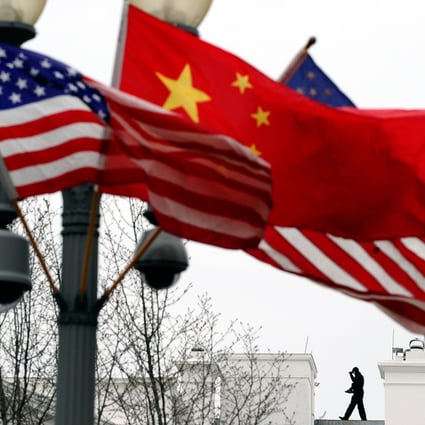 A Secret Service agent guards his post on the roof of the White House as a lamp post is adorned with Chinese and US national flags. The Pentagon’s move to counter China in the Indo-Pacific is certain to vex Beijing. Photo: AFP