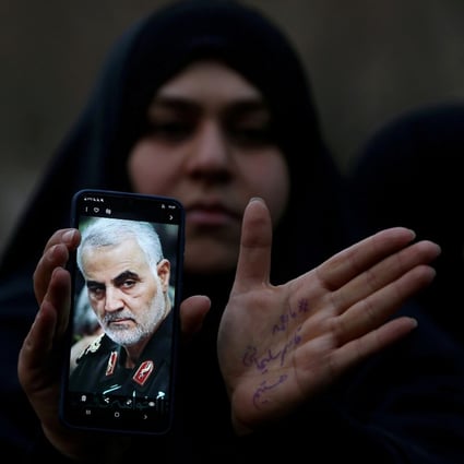 An Iranian woman with a photo of General Qassem Soleimani, who was assassinated in a US air strike. Photo: Reuters