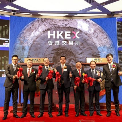 The senior executives of the seven companies that debuted on the Hong Kong stock exchange on Thursday open the day’s trading session. Photo: Xiaomei Chen
