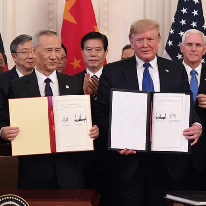 Chinese Vice-Premier Liu He and US President Donald Trump display the signed phase one US-China trade agreement at the White House in Washington on Wednesday. Photo: AFP