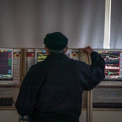 An investor monitors stock prices at a securities brokerage in Beijing. Photo: EPA-EFE