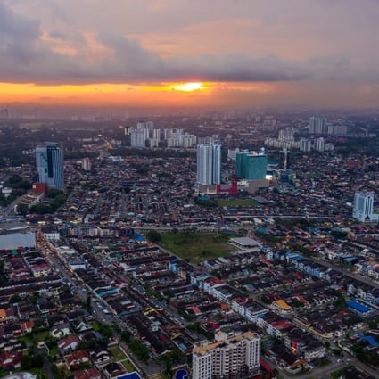 The sun sets above residential and commercial buildings in Johor Bahru, Johor, Malaysia. Its rich Chinese heritage is being used to help promote the city as an attractive travel destination. Photo: Bloomberg