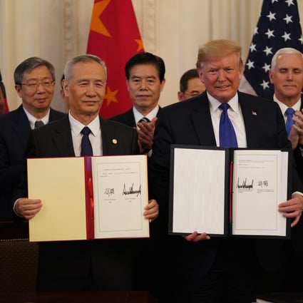 Chinese Vice-Premier Liu He and US President Donald Trump show their signed trade agreement during a ceremony at the White House in Washington on Wednesday. But American businesses say there is much more to get done. Photo: Xinhua