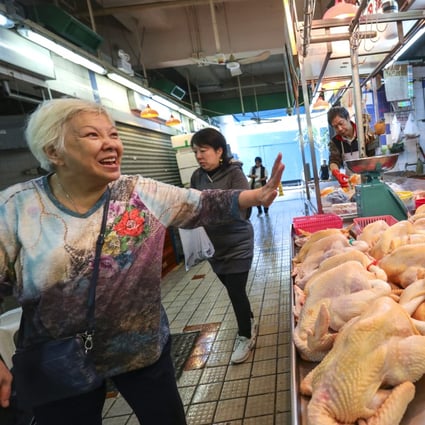 Having a laugh at the Kowloon City wet market last December. Hong Kong’s rankings in the World Happiness Report have fallen from 46th when the report was first published in 2012. Photo: May Tse