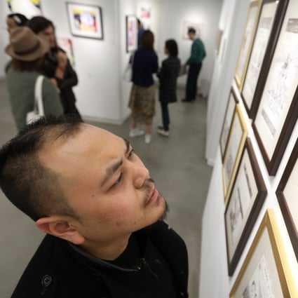 Artist Chow Chun-fai with one of his works at the opening of the ‘What's On Paper’ exhibition, at Hong Kong Visual Arts Centre, in December. Photo: Xiaomei Chen