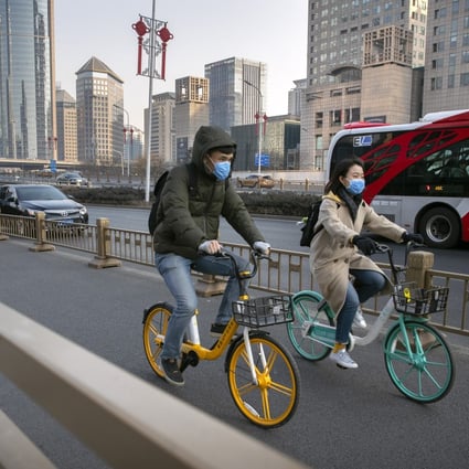 Cyclists wear masks in Beijing amid a coronavirus outbreak in China. The Shanghai Composite, Shenzhen Component and ChiNext indices all rose on Wednesday. Photo: AP