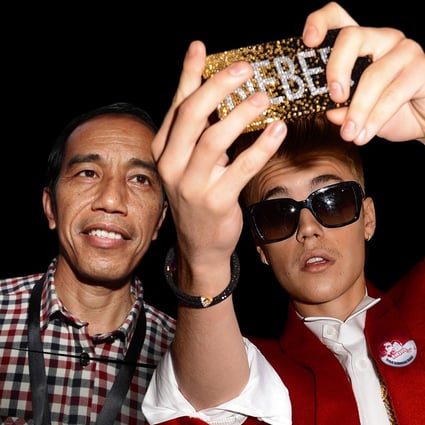 Indonesian President Joko Widodo and singer Justin Bieber do a selfie on one of Agan Harahap’s photos. Photo: courtesy of Agan Harahap