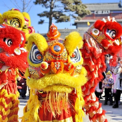 Artists perform a lion dance at Shanhaiguan Pass, in Qinhuangdao city, Hebei province, in northern China. Photo: Xinhua