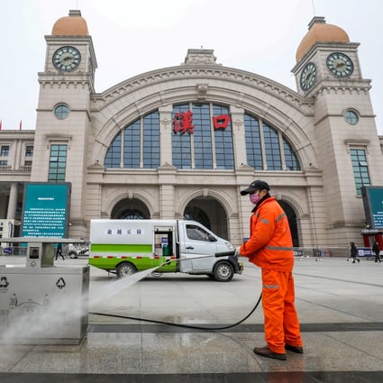 A worker disinfects the square in front of the Hankou train station in Wuhan on Thursday. Photo: Reuters
