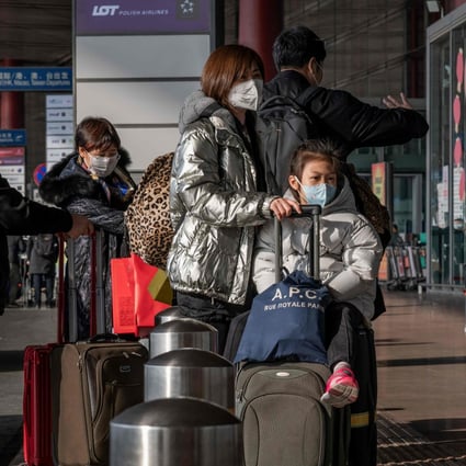 Travellers wearing masks as they head for the departure hall at Beijing Capital International Airport on January 22. Photo: AFP