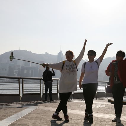 Tourists pose for photos at the Avenue of Stars in Tsim Sha Tsui, Hong Kong on December 3, 2019. Photo: Dickson Lee