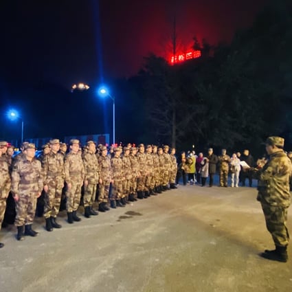 Military medical workers prepare to leave Chongqing for Wuhan on Friday night. Photo: Xinhua