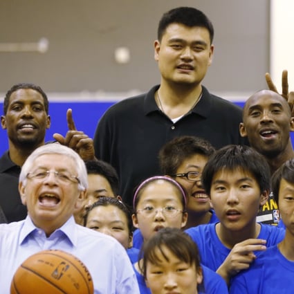 Kobe Bryant, Yao Ming and NBA commissioner David Stern pose with children during the NBA Cares Special Olympics Basketball Clinic in Shanghai in 2013. Photo: AP
