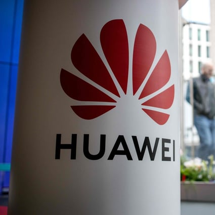 A pedestrian walks past a Huawei product stand at an EE telecommunications shop in central London on April 29, 2019. Photo: AFP