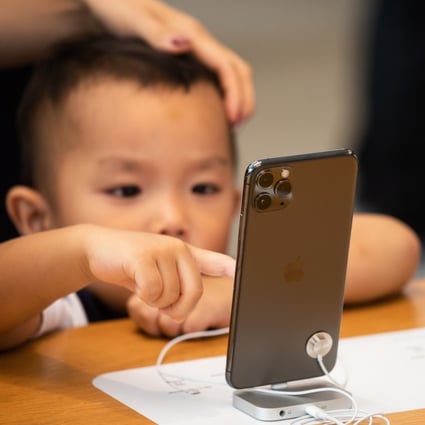 A child tries an iPhone 11 Pro Max smartphone during a product launch at an Apple Store in Hong Kong on September 20, 2019. Photo: Bloomberg