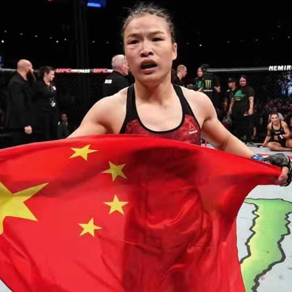 Zhang Weili celebrates with the Chinese flag after winning the UFC strawweight title in Shenzhen. Photo: Brandon Magnus/Zuffa LLC