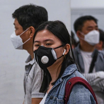 Passengers wearing face masks queue at the immigration counter upon arrival at the Kuala Lumpur International Airport 2 in Sepang on Wednesday. Photo: AFP