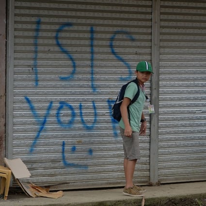Shops in the Philippines sprayed with pro-Islamic State graffiti. Photo: AFP