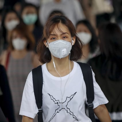 Commuters wearing masks exit the Bangkok Mass Transit System in Thailand’s capital on Thursday. Photo: EPA-EFE