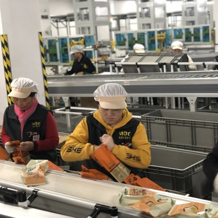 Workers packing snacks along one of the production lines in Three Squirrels’s manufacturing facility in Wuhu, Anhui province on January 23, 2020. Photo: Pearl Liu