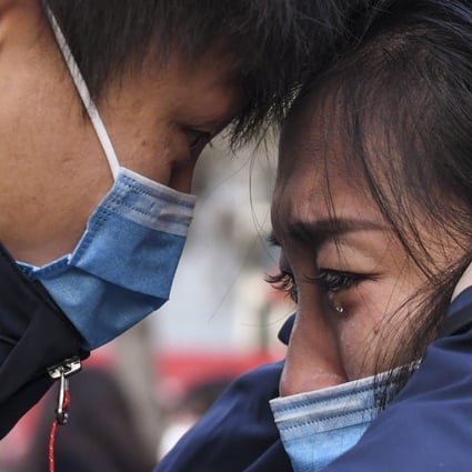 A member of a medical team leaving for Wuhan says goodbye to a loved one in Urumqi on January 28. Instead of looking for blame, we should be throwing our support behind the selfless doctors, nurses and other medical staff risking their lives to contain the outbreak. Photo: Xinhua