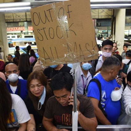 People queue to buy protective masks at a medical supplies store in Manila. Photo: AFP