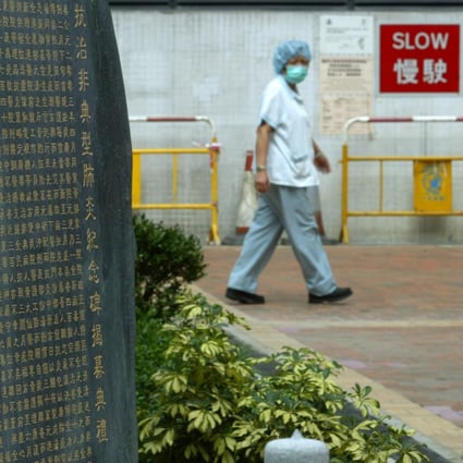 A worker walks past a plaque at Kwong Wah Hospital commemorating Sars victims. Photo: SCMP Pictures