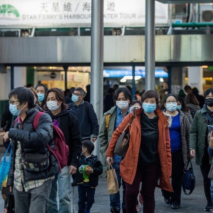 Pedestrians wearing masks walk out of a ferry pier terminal in the Tsim She Tsui district in Hong Kong on Wednesday, Jan. 29, 2020. Photo: Bloomberg