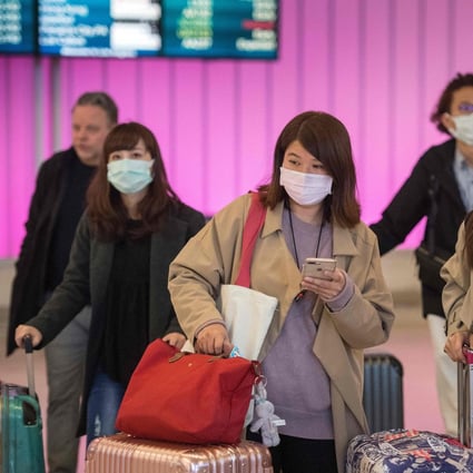 Passengers wear face masks to protect against the novel coronavirus, as they arrive at Los Angeles International Airport on January 22. Photo: AFP