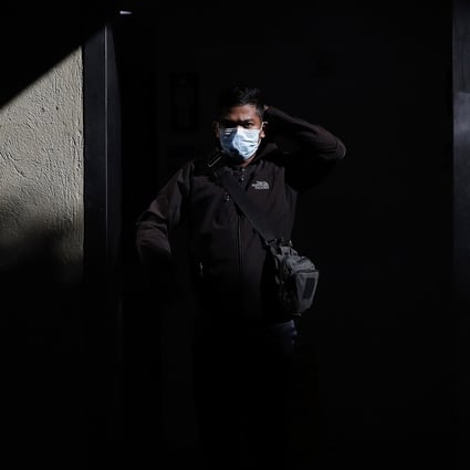 A man wearing a protective mask walks through Manila's international airport. Photo: AP