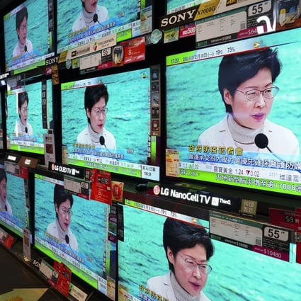 TV screens broadcast Chief Executive Carrie Lam announcing the closure of all but three border crossings with mainland China, in Admiralty on February 3. Photo: Robert Ng