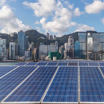 Solar panels are flanked by the Hong Kong skyline. It is already possible to reduce emissions from cities by 90 per cent using proven low-carbon measures such as solar power, mass transit and improved recycling. Photo: Shutterstock