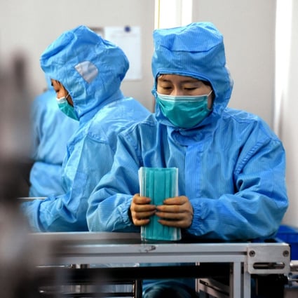Workers make surgical masks in Dingzhou, in northern China’s Hebei province, with medical supplies in urgent demand. Photo: Xinhua