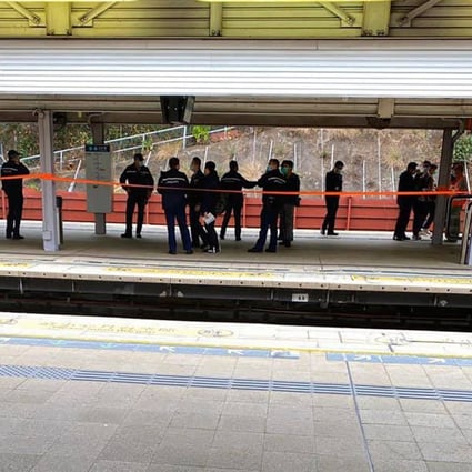 Police officers gather on a platform at Tai Po Market MTR station after a suspicious package was found nearby. Photo: Facebook