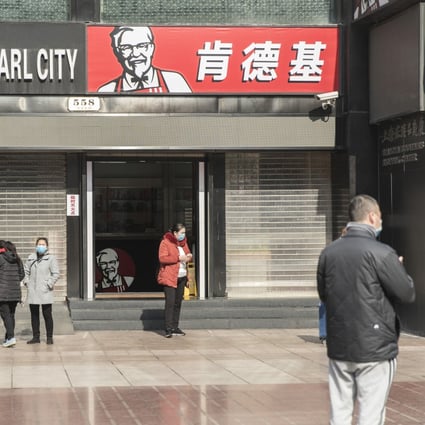 Pedestrians wear protective masks in Shanghai on Wednesday. Yum China’s same-store sales grew 3 per cent year on year in 2019, driven by KFC. Photo: Bloomberg