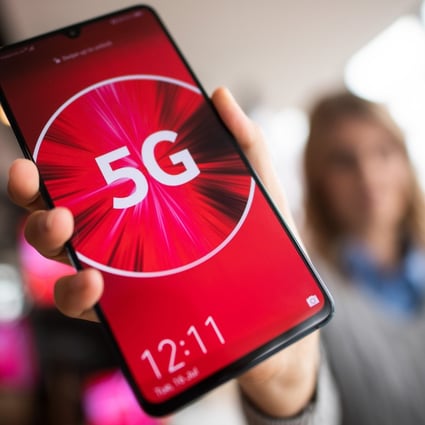 A Vodafone employee holds a 5G smartphone. The company was the first German telecommunications company to launch a commercial 5G network. Photo: Federico Gambarini/dpa