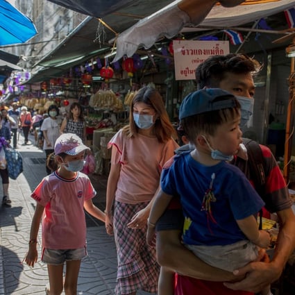 Tourists walk through Bangkok’s Chinatown. Thailand’s central bank has cut its benchmark interest rate to help the economy weather the virus outbreak in China that has devastated its tourism sector. Photo: AP