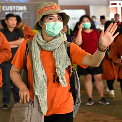 A passenger wearing a face mask walks through Sukarno-Hatta international airport in Indonesia’s Tangerang on Wednesday. Photo: AFP