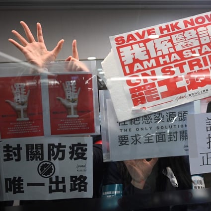 Members of the Hospital Authority Employees Alliance and other medical workers hold placards during a strike at the Hospital Authority building in Hong Kong on February 7. Photo: AFP